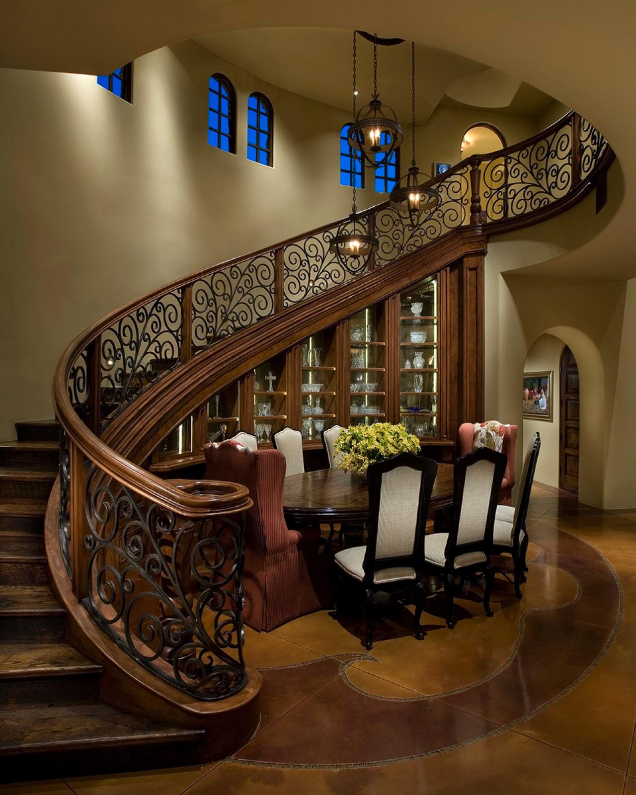 Curved-Staircase-Wraps-Around-Mediterranean-Dining-Room