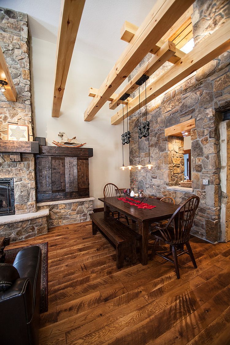 Farmhouse-style-dining-room-with-wooden-beams-stone-walls-and-ingenious-lighting