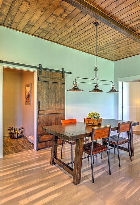 Barn-doors-are-ideal-for-a-dining-room-connected-with-multiple-rooms