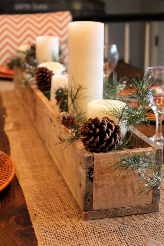 rustic-wooden-box-centerpiece-with-candles-pinecones-and-evergreens